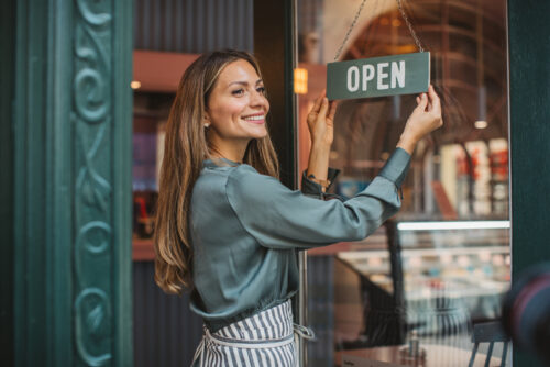 woman opening store